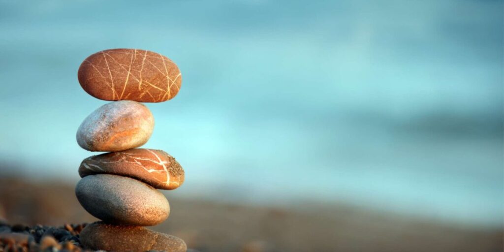 stones stacked in fours by the calm sea filled with love and peace